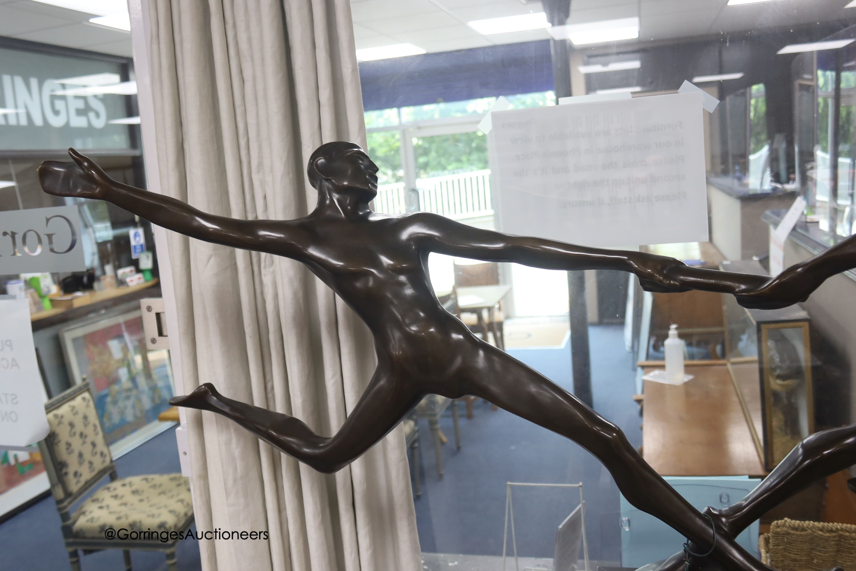 A large bronze of baton runners on faux marble base